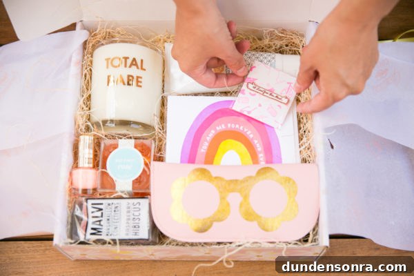 A box with a candle, gummies, and a pin