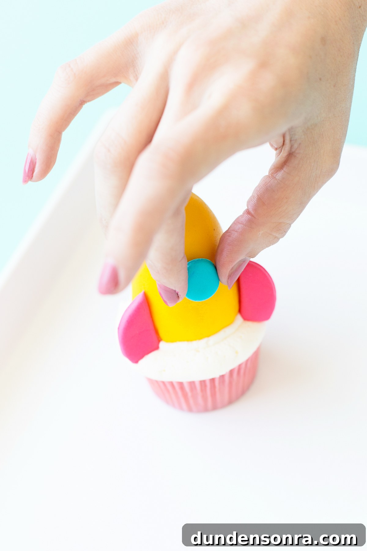 Space-Themed Cupcakes: Step-by-Step Recipe & Decorating Tips 16 Putting rocket ship on cupcake