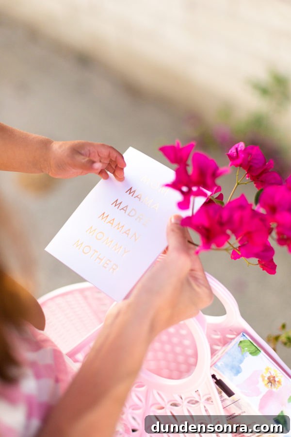 A person holding a card and flowers