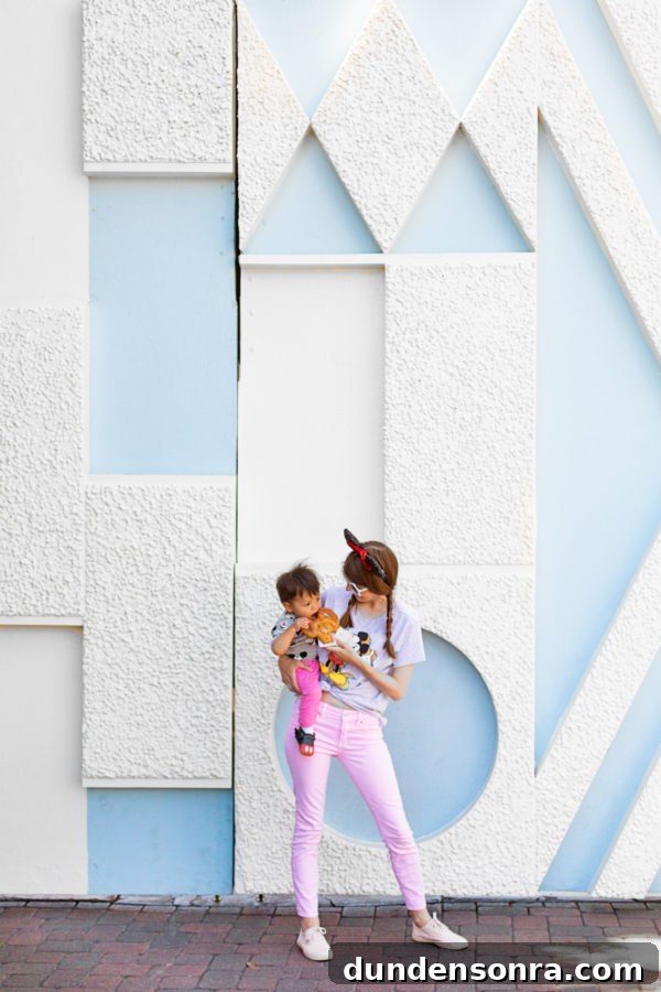 A woman and a little boy in front of a blue and white wall