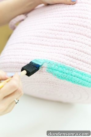 Someone painting a basket  turquoise 