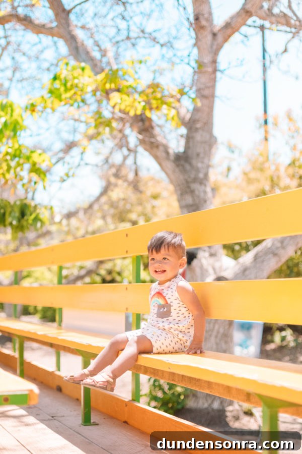A boy sitting on a wooden bench