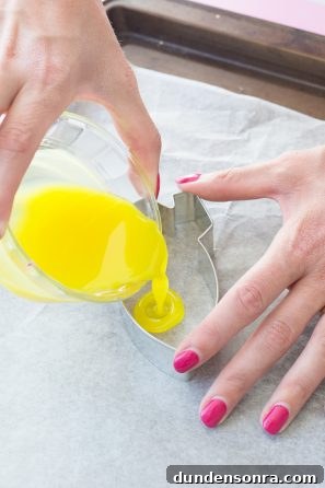 Someone pouring yellow liquid into a tin frame