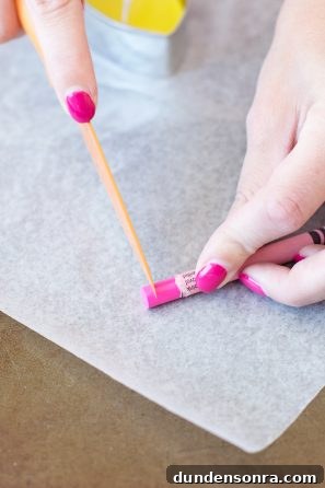 Someone cutting a crayon