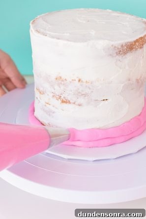 A cake with pink frosting