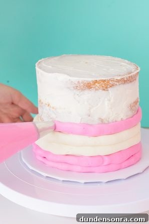 A cake with pink and white frosting