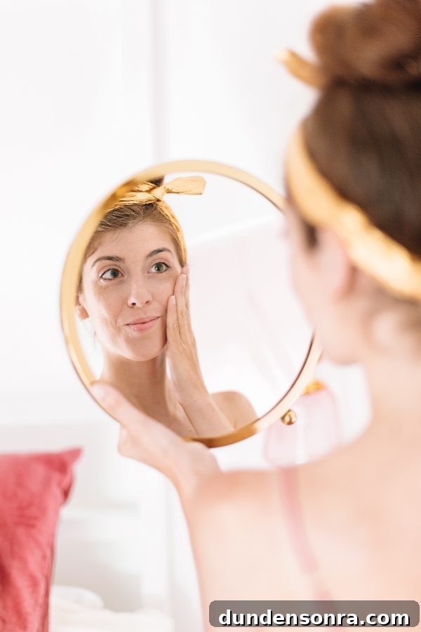 My 28-Day Olay Skincare Challenge: Routine Results & Review 2 A woman looking into a mirror