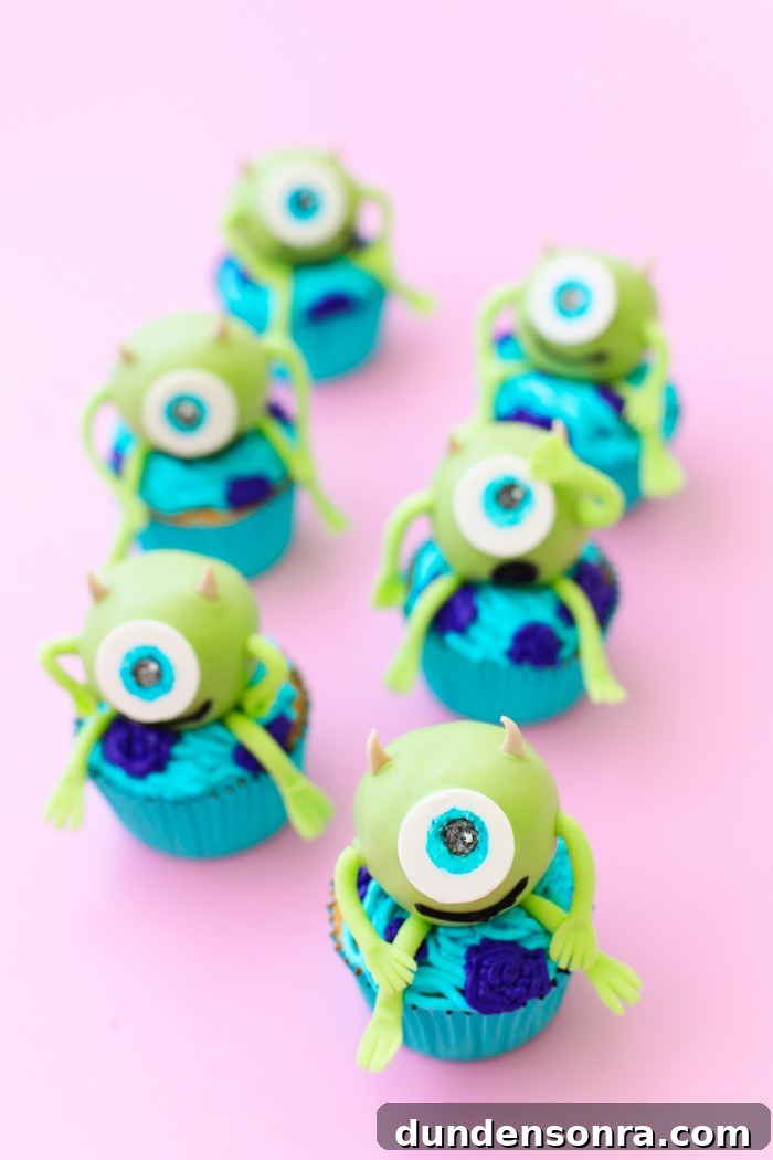 Mike Wazowski cake balls on top of cupcakes
