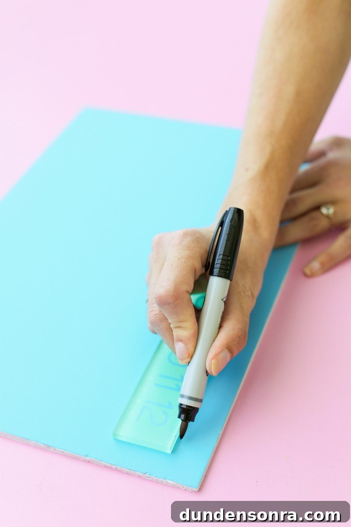 Drawing a line on a foam core door decoration with a black permanent marker