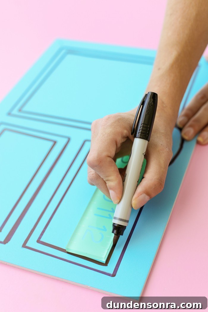 Drawing a line on a foam core door decoration with a black permanent marker