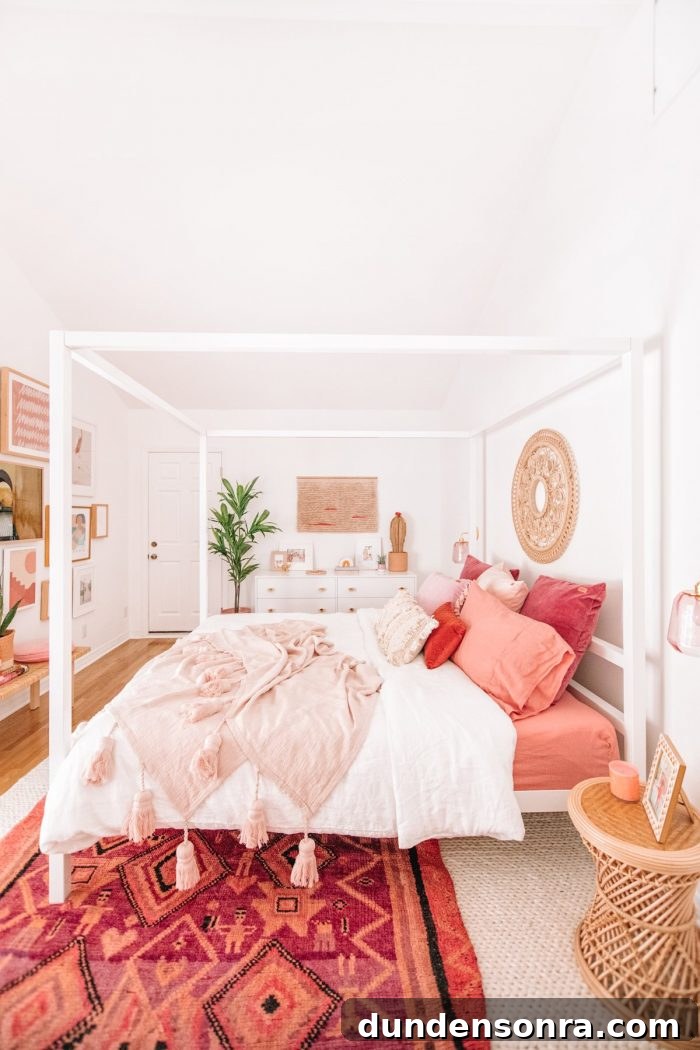 A bedroom with pink blankets and pillows
