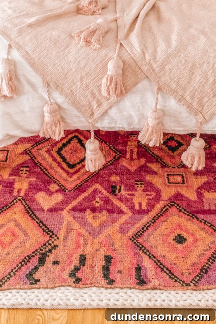Close up of a pink blanket and a rug