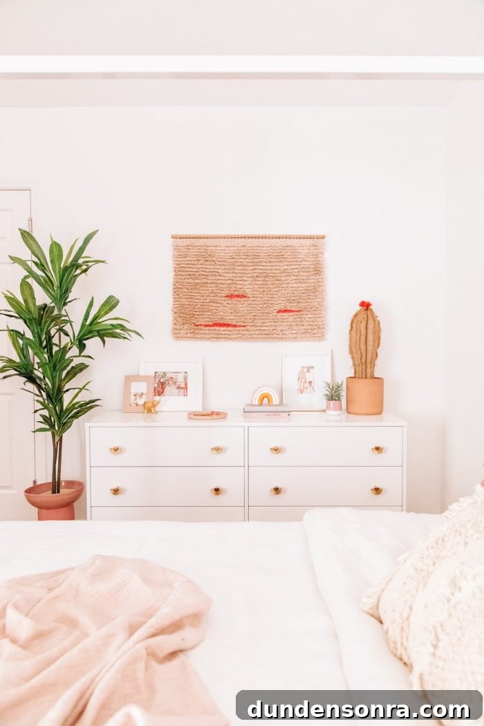 A bedroom with a white dresser