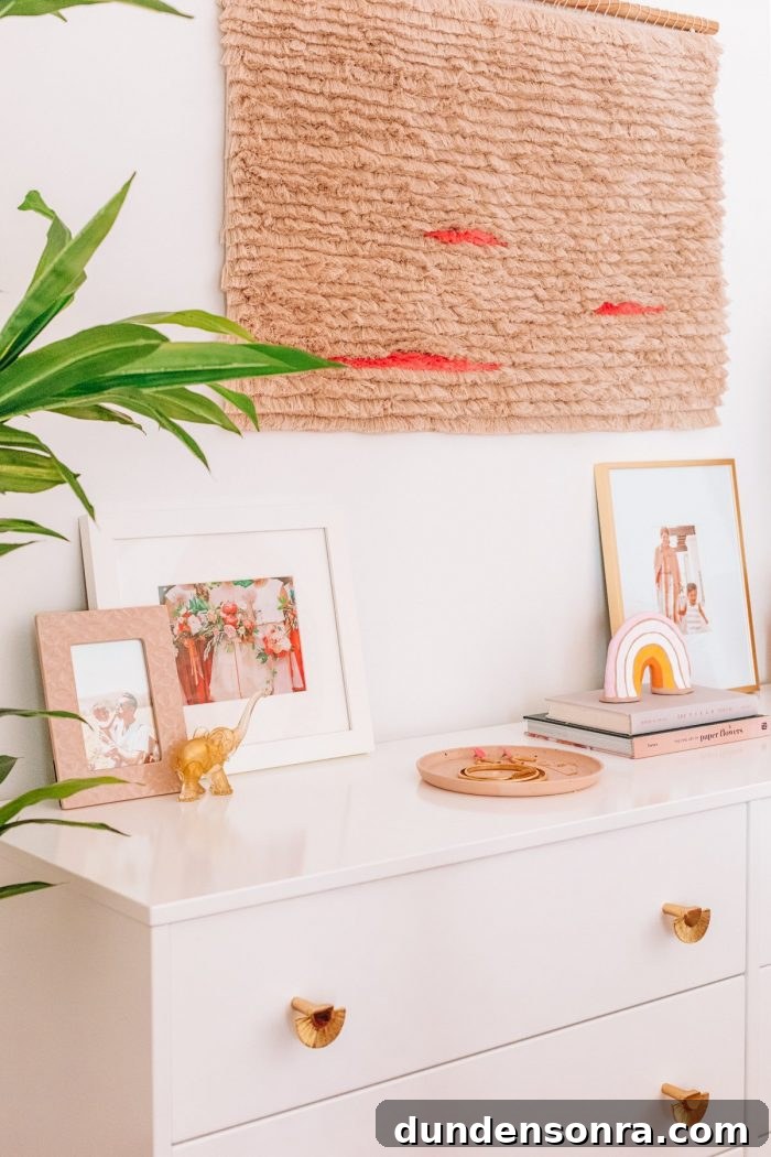 The top of a dresser with art and plants