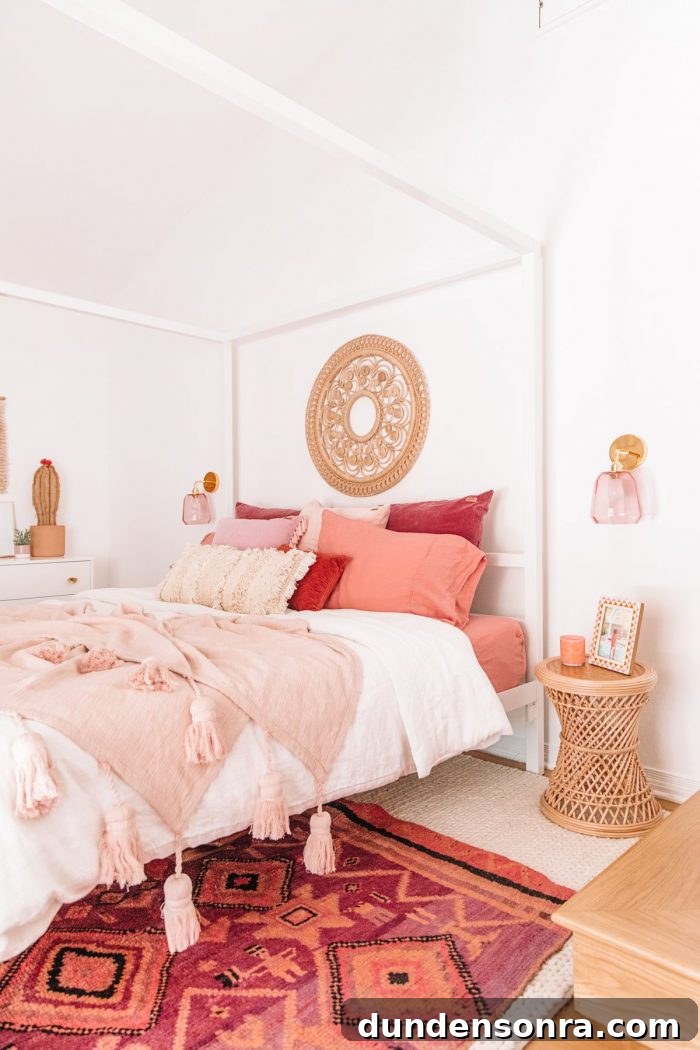 A bed with pink pillows and pink blankets