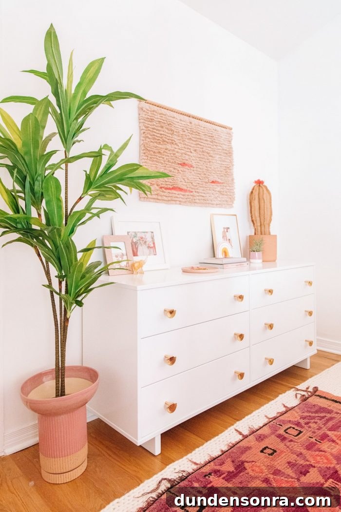 A room with a white dresser and plants
