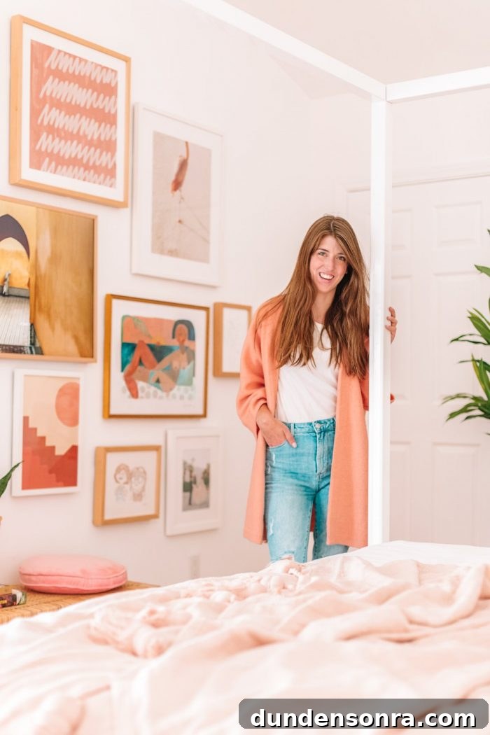 A woman standing next to a bed