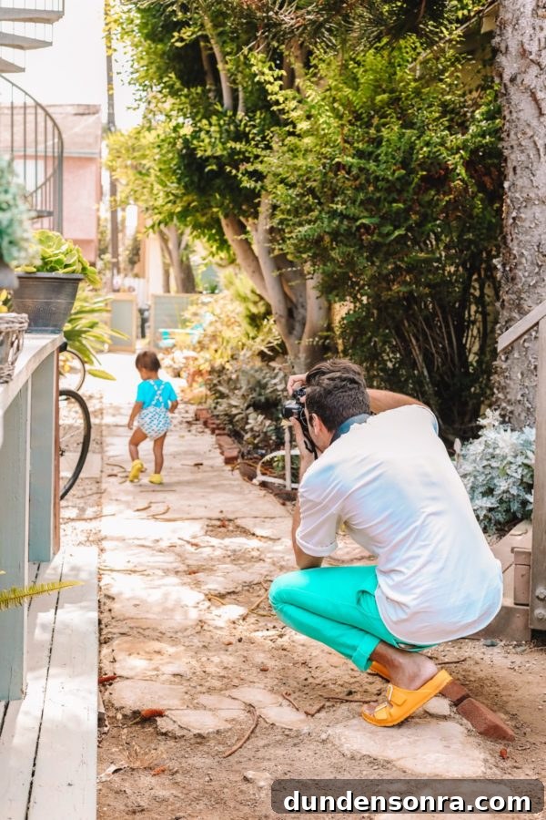 A man taking a photo of a little boy
