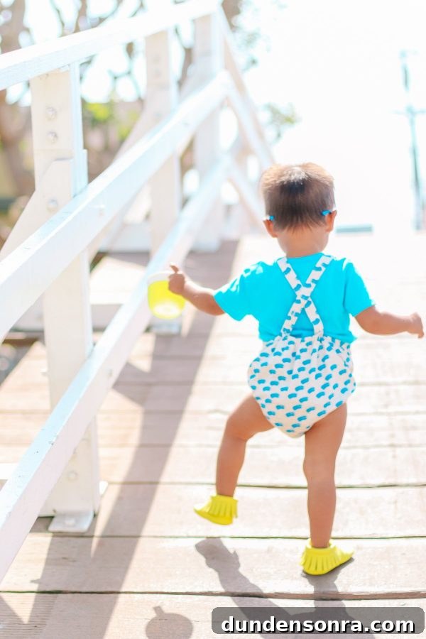 A boy walking down a boardwalk