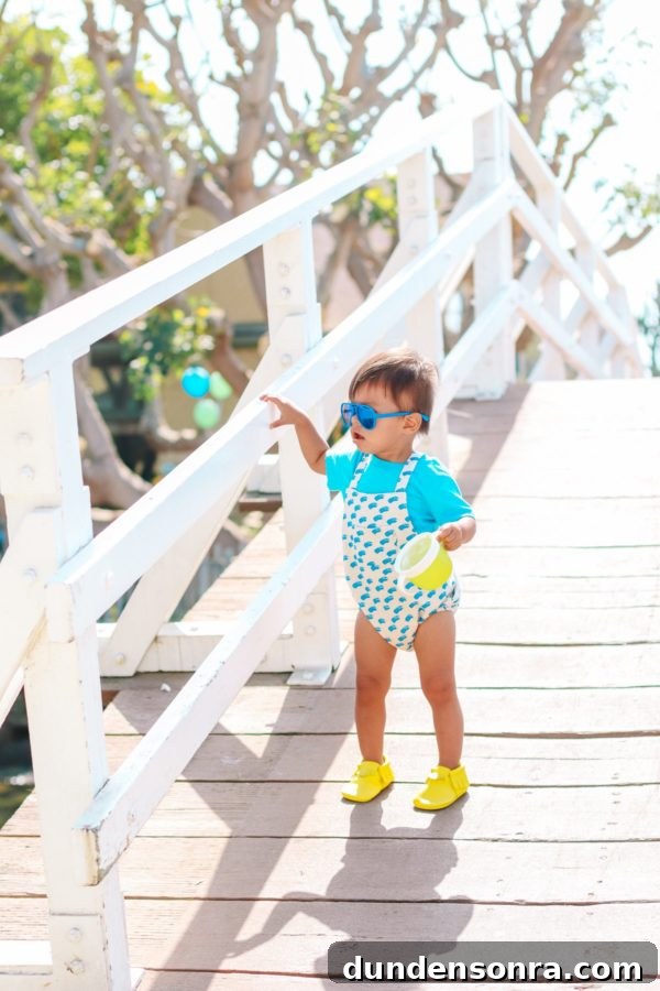 A little boy walking down a wooden path