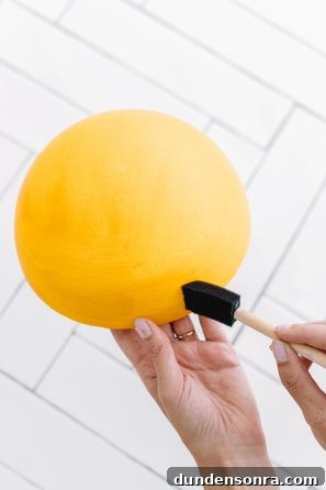 Creative DIY Weather-Themed Family Costume Ideas 5 Someone painting a yellow dome