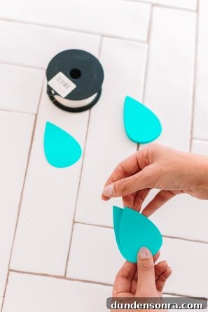 Creative DIY Weather-Themed Family Costume Ideas 10 Someone holding paper raindrops