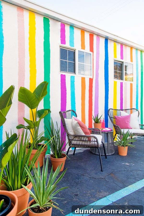 Two chairs in front of a colorful wall