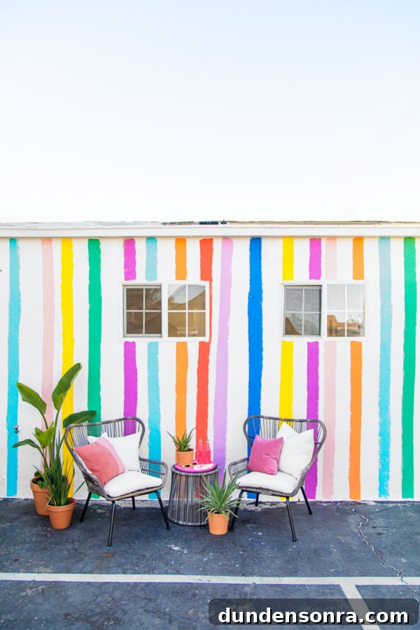 Two chairs in front of a rainbow wall