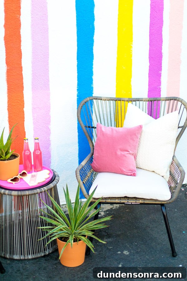 A chair and table in front of a rainbow wall