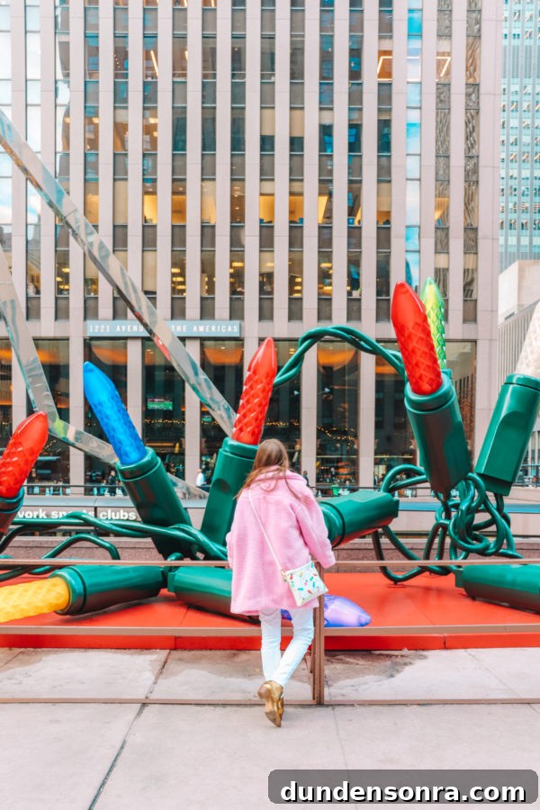 Arlo’s First Christmas in New York City: A Festive NYC Holiday Adventure 13 Someone looking at giant Christmas lights