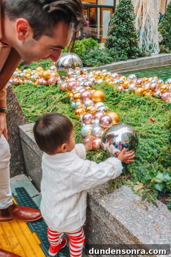 Arlo’s First Christmas in New York City: A Festive NYC Holiday Adventure 6 A little boy holding a ball