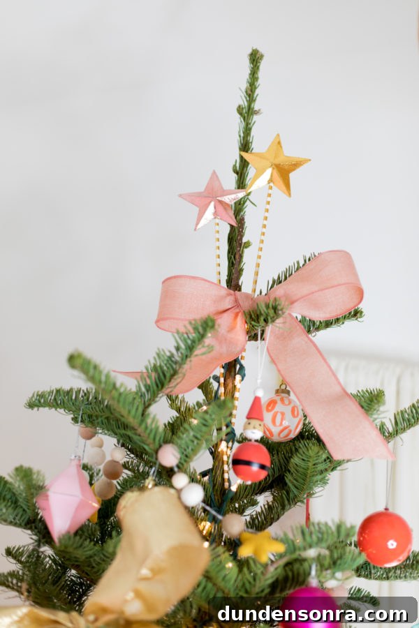 Holiday Home Tour: Inside The Mindwelling’s Festive Decor 4 A bow on top of a christmas tree