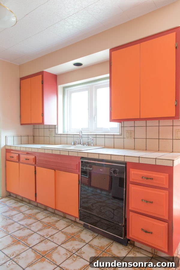 A kitchen with orange cabinets 