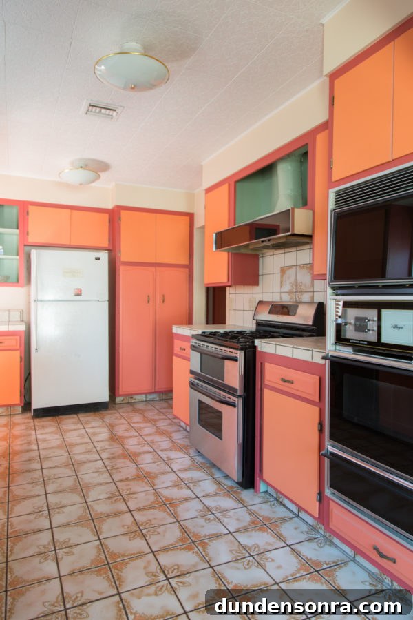 A kitchen with a stove and a refrigerator
