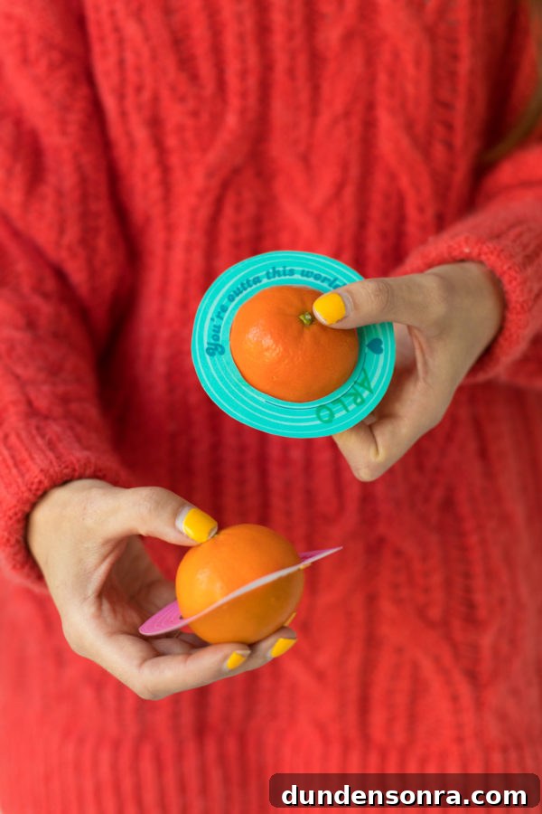 Printable Outer Space Valentines for Toddlers — DIY Cards to Make and Share 9 An orange with paper around it