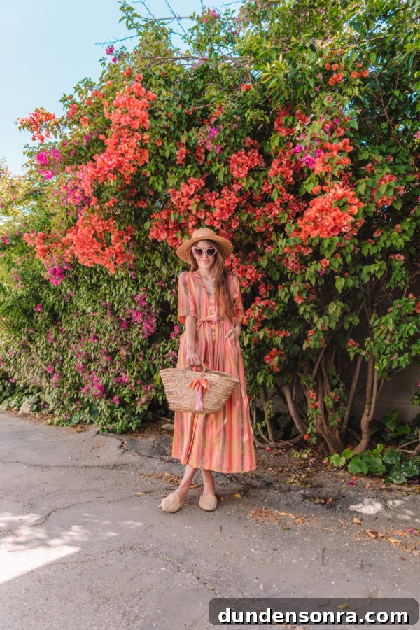 A woman standing in front of flowers