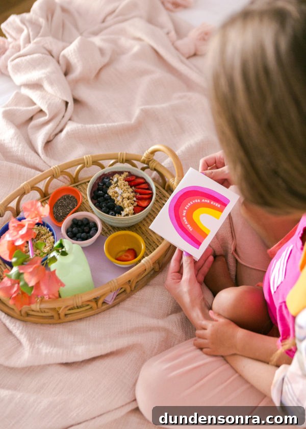 A baby sitting on a bed