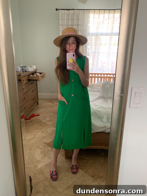 A woman standing in front of a mirror posing for the camera, with Straw Hat