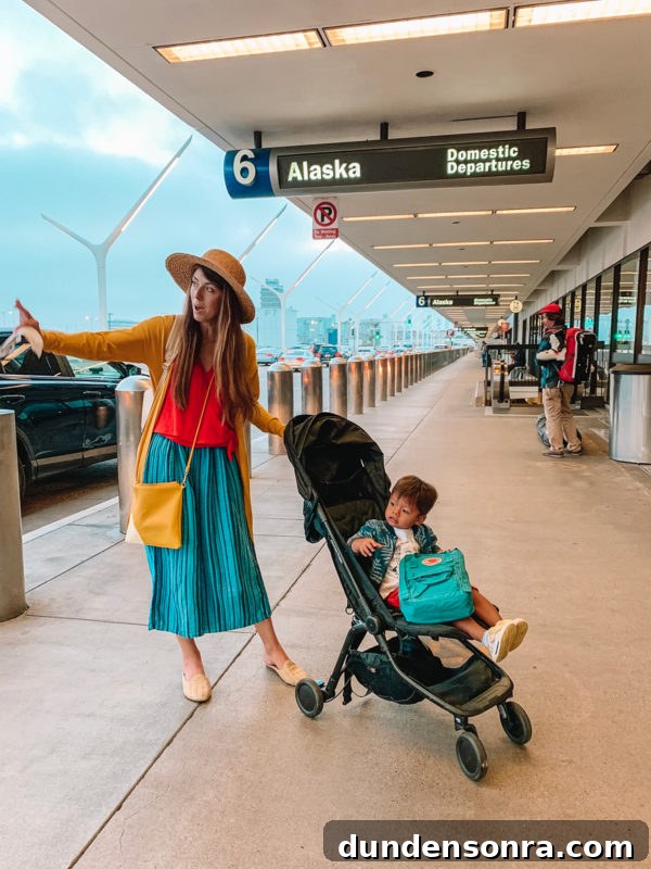 Flying With a Baby or Toddler: Tips, Gear & Plane Activities 5 A group of people standing at an airport