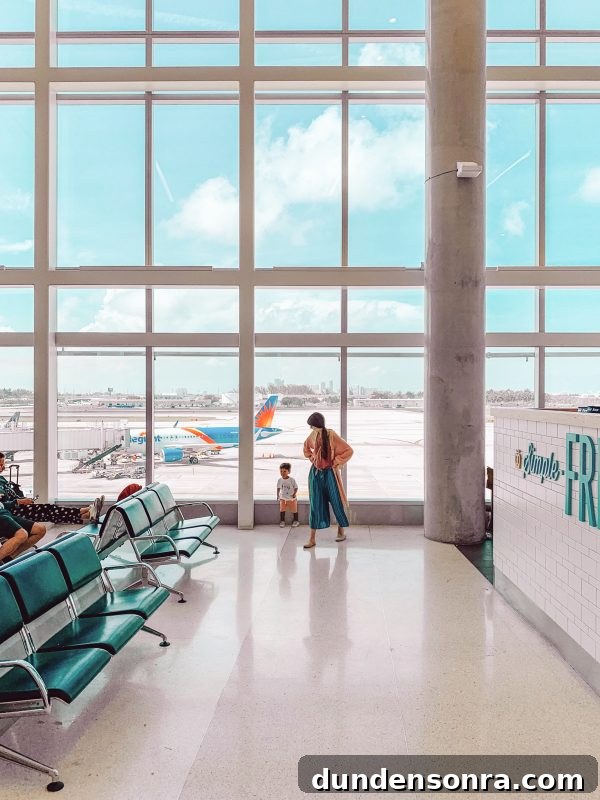 Flying With a Baby or Toddler: Tips, Gear & Plane Activities 6 Two people in an airport