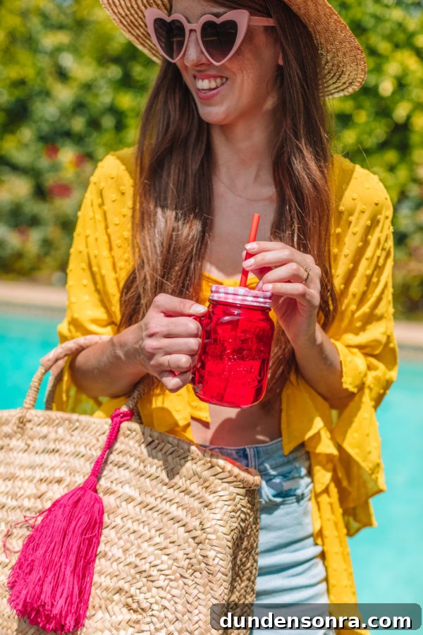 Family Pool Day Packing List: Essentials for Parents and Kids 8 A woman holding a red glass