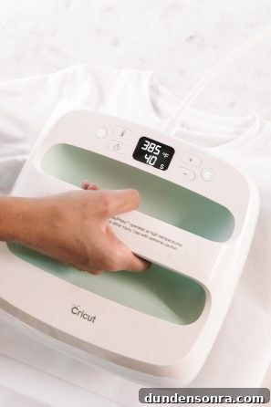 Someone holding a cricut machine