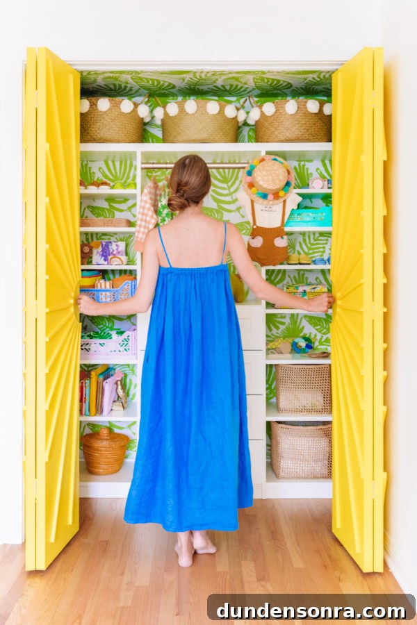 A little girl standing in front of a closet