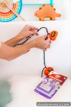 Someone holding pumpkin lights