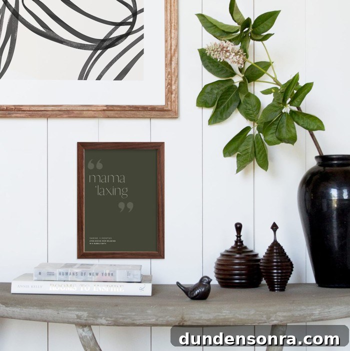 Table with black vase and green art print on wall