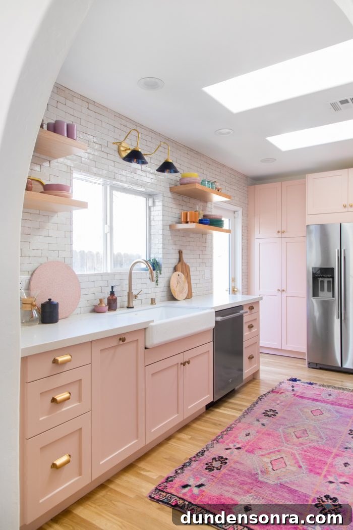 Home Renovation Progress: Completed Work and Remaining Tasks 21 A kitchen with pink cabinets, a sink and a window