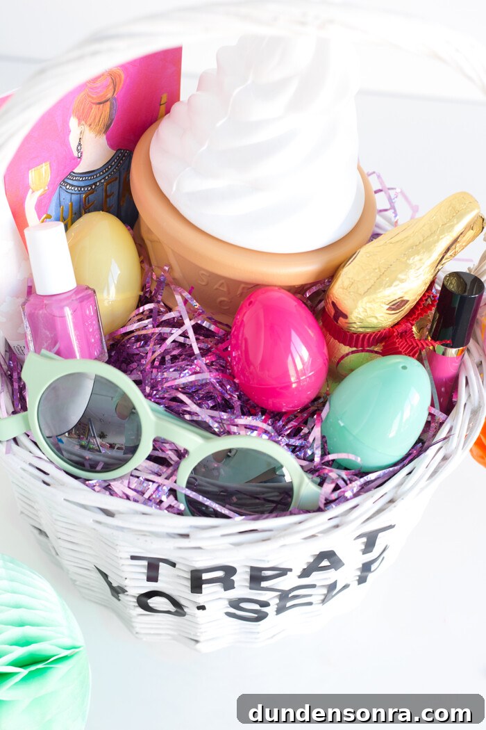 White basket filled with purple shredded paper with sunglasses, nail polish, lipstick and chocolate in the basket. 