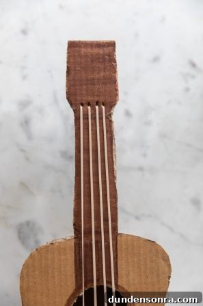A close up of a cardboard guitar