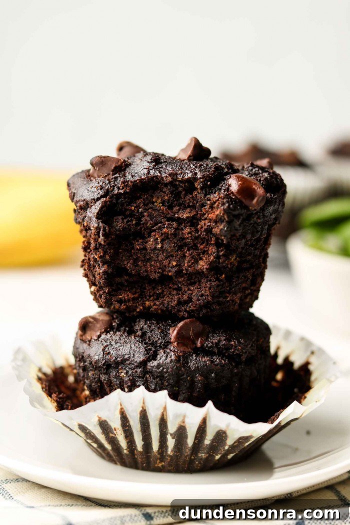 Favorite Breakfast Recipes Our Family Loves 15 chocolate green smoothie muffins stacked on top of each other on a plate