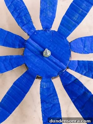 Build a Cardboard Dumbo Ride: Step-by-Step DIY Guide 10 A blue flower shape